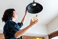 Woman changing lightbulb