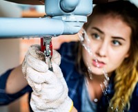 Woman fixing her own toilet sink