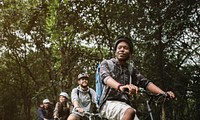 Group of friends ride mountain bike in the forest together