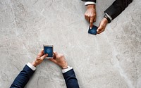 Business people syncing data by mobile phone