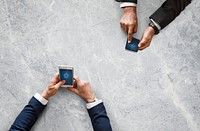 Business people syncing data by mobile phone