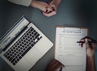 Aerial view of doctor writing patient daily report checklist