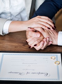 Married elderly couple with marriage certificate