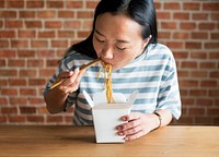 Chinese woman eating Chow mein