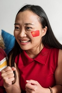 Friends cheering world cup with painted flag