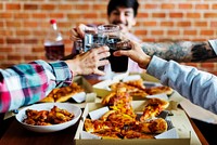 Friends eating pizza together at home<br />