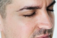 Side portrait of white man closeup on closed eyes