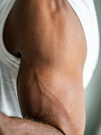 Closeup of a black person&#39;s muscular arm