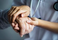 Doctor holding patient&#39;s hand, closeup photo