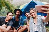 Group of friends taking a selfie at a campsite