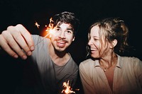 Friends having fun with sparklers in the night