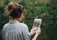 Woman alone in nature listening to music with headphones
