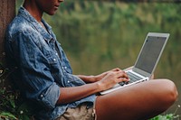 Woman alone in nature using a laptop