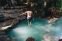 White man enjoying the waterfall