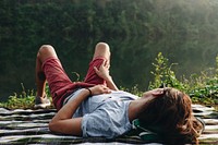 Man relaxing by a lake in the forest