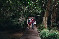 Group of friends walking through a forest