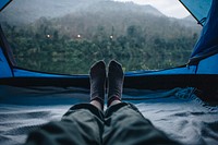 Woman sleeping in a tent with an amazing view