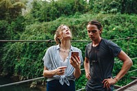 Caucasian woman and man having a bad cellular signal in the nature travel problem concept