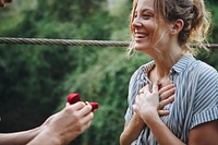 Man proposing to his woman with a red box