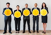 Business people standing and holding currency icons