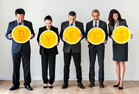 Business people standing and holding currency icons