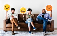 Diverse people sitting and holding emojis logos