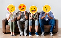 Diverse people sitting and covering face with emojis boards
