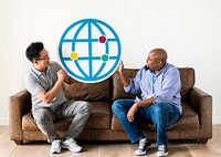 Diverse men holding browser icon sitting on couch