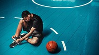 Basketball player tying his shoelaces wallpaper