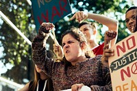 Closeup of angry teen girl protesting demonstration holding posters antiwar justice peace concept