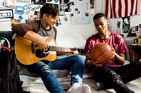 Teenage boys hanging out in a bedroom music and sports hobby concept