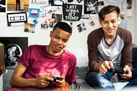 Teenage boys hanging out in a bedroom playing video games together