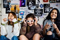 Teenage girls wearing 3d movie eyeglasses enjoying laughing and watching TV