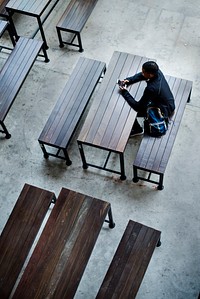 Teenage boy sitting alone in an empty canteen