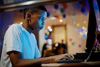 African american boy using a computer at night<br />