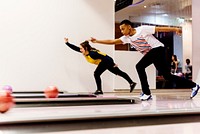 Teen boys bowling together