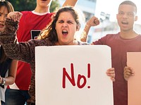 Closeup of angry teen girl protesting demonstration holding posters antiwar justice peace concept