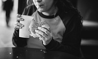 Close up of teenage girl eating hamburger