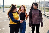 Teenage girl friends walking together