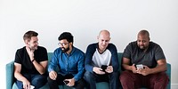 Group of diverse men using mobile phone