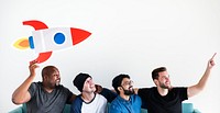 Group of diverse friends sitting on couch with spaceship icon