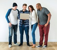 Group of diverse friends using laptop together