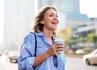 Woman on the go with take away coffee