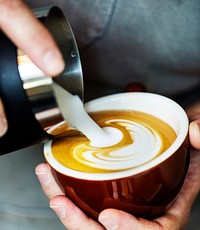 Closeup of barista making latte art