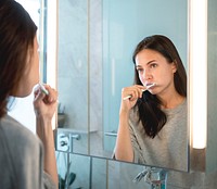 Woman brushing her teeth in the morning