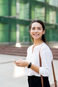Asian woman smiling and playing on phone