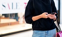 Woman using mobile phone at shopping mall