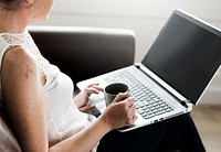 White woman using laptop at sofa