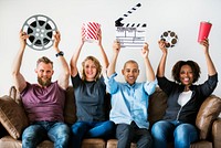 Group of friends holding movie and film objects