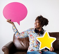Happy African American holding copyspace speech bubble and a star sign